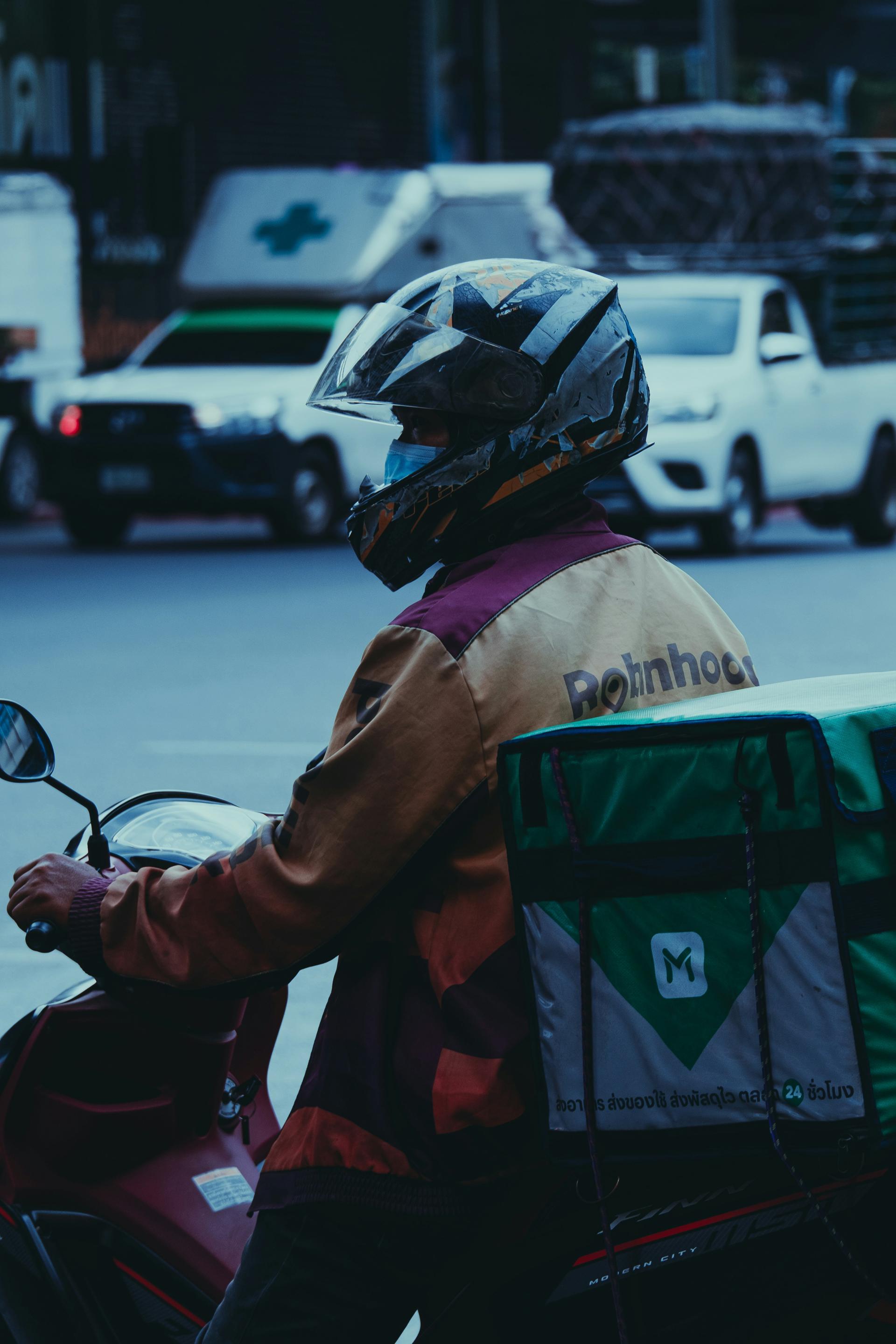 Food delivery person on motorcycle with insulated bag